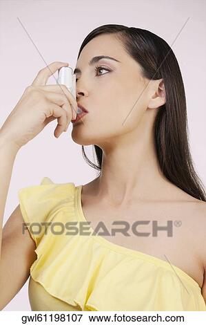 Close-up of a woman using an inhaler View Large Photo Image Stock Photo - Close-up of a woman using an inhaler. Fotosearch