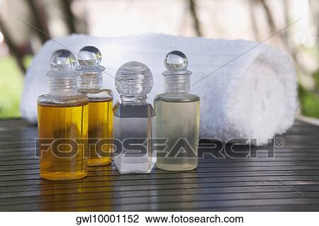 Close-up of aromatherapy oil bottles with a towel View Large Photo Image Stock Image - Close-up of aromatherapy oil bottles with a towel. Fotosearch