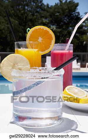 Picture - Close-up of assorted drinks at the poolside. Fotosearch