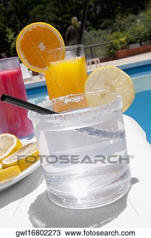 Close-up of assorted drinks at the poolside View Large Photo Image Stock Image - Close-up of assorted drinks at the poolside. Fotosearch