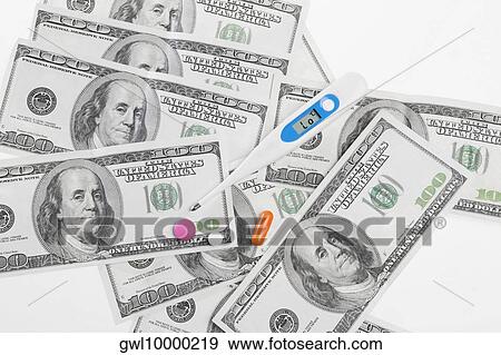 Close-up of hundred dollar bills with pills and a thermometer View Large Photo Image Stock Photo - Close-up of hundred dollar bills with pills and a thermometer. Fotosearch