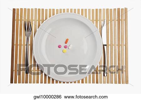 Close-up of pills on a plate View Large Photo Image Stock Photograph - Close-up of pills on a plate. Fotosearch