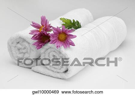 Close-up of rolled up towels with flowers View Large Photo Image Stock Photo - Close-up of rolled up towels with flowers. Fotosearch