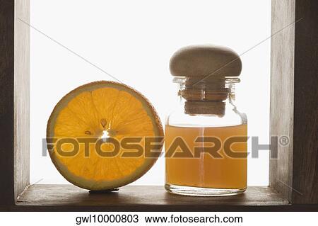 Close-up of therapeutic oil with an orange half View Large Photo Image Stock Image - Close-up of therapeutic oil with an orange half. Fotosearch