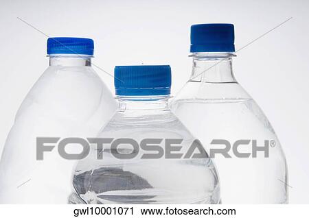 Close-up of three bottles of water View Large Photo Image Stock Image - Close-up of three bottles of water. Fotosearch