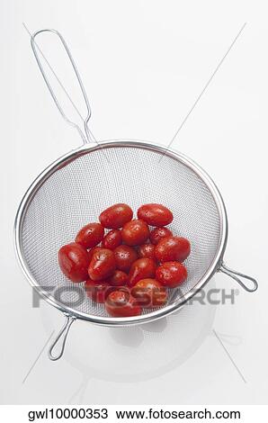 Stock Image - Close-up of tomatoes in a sieve. Fotosearch