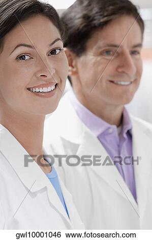 Close-up of two doctors smiling in a laboratory View Large Photo Image Stock Photograph - Close-up of two doctors smiling in a laboratory. Fotosearch