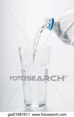 Close-up of water pouring from a bottle into a glass View Large Photo Image Stock Image - Close-up of water pouring from a bottle into a glass. Fotosearch