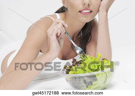 Stock Photo - Close-up of woman eating salad. Fotosearch
