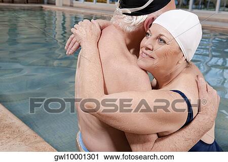 Couple embracing in a swimming pool View Large Photo Image Stock Image - Couple embracing in a swimming pool. Fotosearch