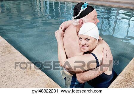 Couple embracing in a swimming pool View Large Photo Image Stock Image - Couple embracing in a swimming pool. Fotosearch