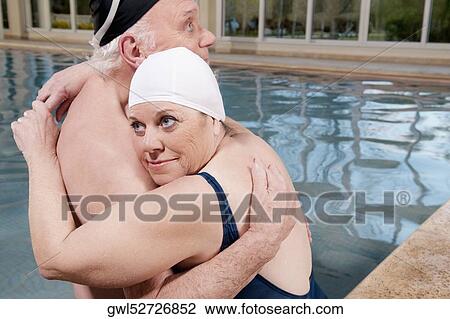 Couple embracing in a swimming pool View Large Photo Image Stock Image - Couple embracing in a swimming pool. Fotosearch