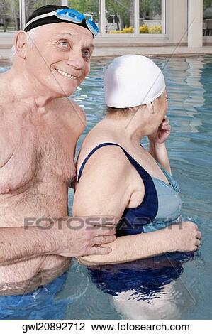 Couple enjoying in a swimming pool View Large Photo Image Stock Image - Couple enjoying in a swimming pool. Fotosearch