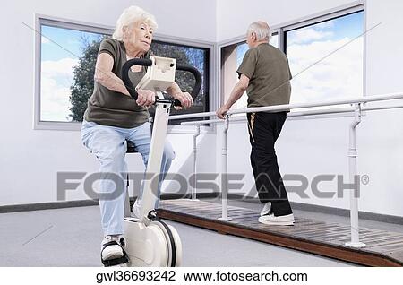 Couple exercising in a rehabilitation center View Large Photo Image Stock Image - Couple exercising in a rehabilitation center. Fotosearch