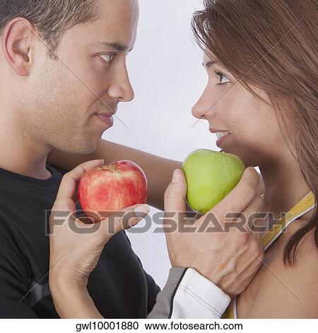 Couple holding apples and romancing View Large Photo Image Stock Image - Couple holding apples and romancing. Fotosearch