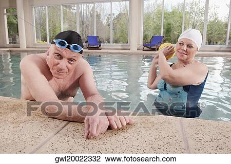 Stock Image - Couple in a swimming pool. Fotosearch