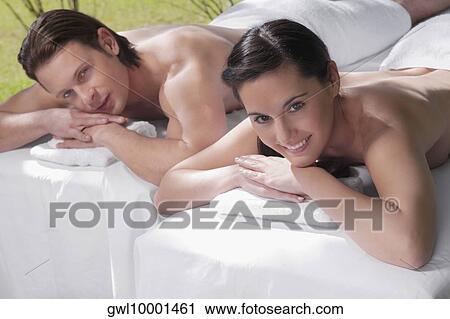 Stock Image - Couple lying on massage tables. Fotosearch