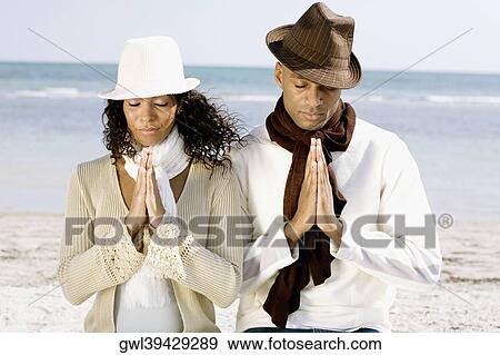 Couple meditating on the beach View Large Photo Image Stock Photo - Couple meditating on the beach. Fotosearch