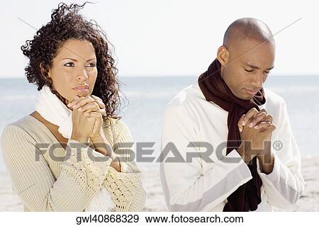 Couple meditating on the beach View Large Photo Image Stock Photo - Couple meditating on the beach. Fotosearch