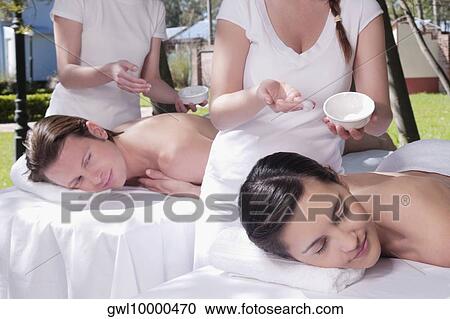 Couple receiving back massage from massage therapists View Large Photo Image Stock Image - Couple receiving back massage from massage therapists. Fotosearch