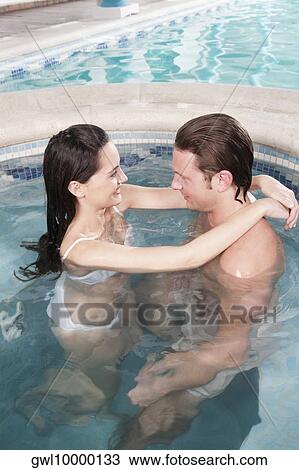 Stock Image - Couple romancing in a hot tub. Fotosearch