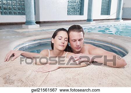 Couple romancing in a hot tub View Large Photo Image Stock Photo - Couple romancing in a hot tub. Fotosearch