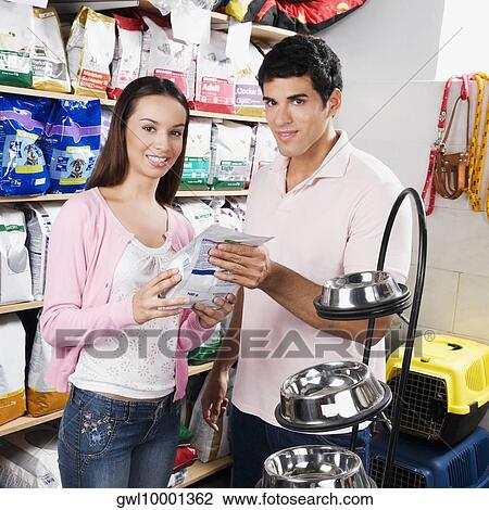 Couple shopping dog food in a supermarket View Large Photo Image Stock Image - Couple shopping dog food in a supermarket. Fotosearch