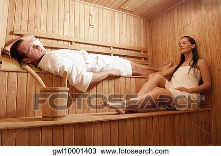 Stock Image - Couple taking a sauna bath. Fotosearch