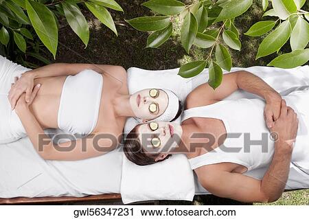 Couple with face pack and cucumber slices on their eyes View Large Photo Image Stock Image - Couple with face pack and cucumber slices on their eyes. Fotosearch