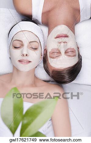 Couple with face pack on their faces View Large Photo Image Stock Photo - Couple with face pack on their faces. Fotosearch