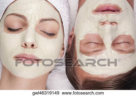 Couple with face pack on their faces View Large Photo Image Stock Photo - Couple with face pack on their faces. Fotosearch