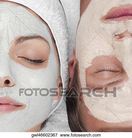 Stock Photo - Couple with face pack on their faces. Fotosearch