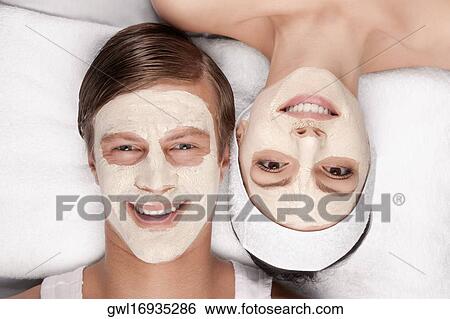 Couple with face pack on their faces View Large Photo Image Stock Photograph - Couple with face pack on their faces. Fotosearch