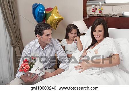Couple with their newborn baby in a hospital View Large Photo Image Stock Image - Couple with their newborn baby in a hospital. Fotosearch