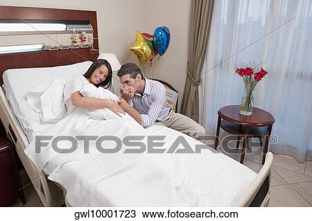 Couple with their newborn baby in a hospital View Large Photo Image Stock Image - Couple with their newborn baby in a hospital. Fotosearch