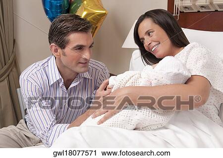 Couple with their newborn baby in a hospital View Large Photo Image Stock Image - Couple with their newborn baby in a hospital. Fotosearch