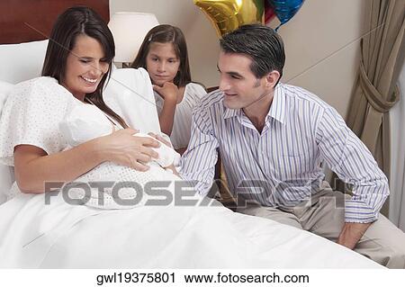 Couple with their newborn baby in a hospital View Large Photo Image Stock Image - Couple with their newborn baby in a hospital. Fotosearch