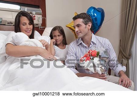 Couple with their newborn baby in a hospital View Large Photo Image Stock Photo - Couple with their newborn baby in a hospital. Fotosearch