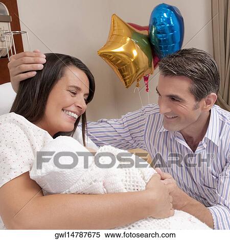 Couple with their newborn baby in a hospital View Large Photo Image Stock Photography - Couple with their newborn baby in a hospital. Fotosearch