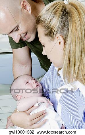 Couple with their newborn baby View Large Photo Image Stock Image - Couple with their newborn baby. Fotosearch