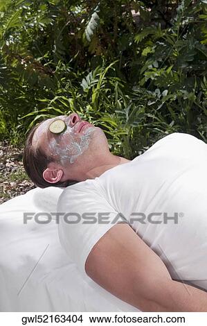 Cucumber slice on a man's eye View Large Photo Image Picture - Cucumber slice on a man's eye. Fotosearch