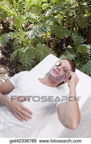 Cucumber slice on a man's eye View Large Photo Image Stock Photo - Cucumber slice on a man's eye. Fotosearch