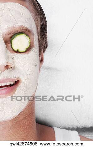 Cucumber slice on a man's eye View Large Photo Image Stock Photograph - Cucumber slice on a man's eye. Fotosearch