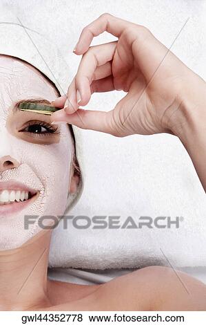Cucumber slice on a woman's eye View Large Photo Image Stock Photo - Cucumber slice on a woman's eye. Fotosearch