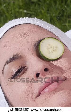 Cucumber slice on a woman's eye View Large Photo Image Stock Photo - Cucumber slice on a woman's eye. Fotosearch