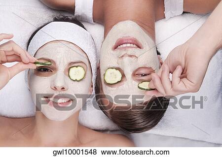 Cucumber slices on a couple's eyes View Large Photo Image Stock Photo - Cucumber slices on a couple's eyes. Fotosearch