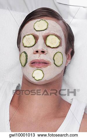 Cucumber slices on a man's face View Large Photo Image Stock Image - Cucumber slices on a man's face. Fotosearch
