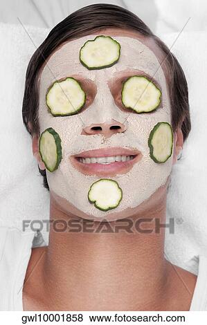 Cucumber slices on a man's face View Large Photo Image Stock Photo - Cucumber slices on a man's face. Fotosearch