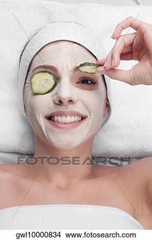 Cucumber slices on a woman's eyes View Large Photo Image Picture - Cucumber slices on a woman's eyes. Fotosearch
