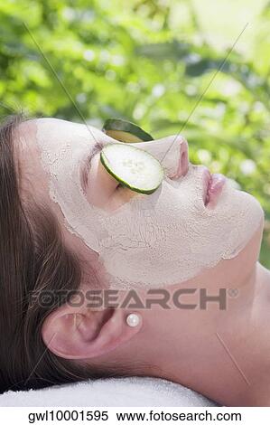 Cucumber slices on a woman's eyes View Large Photo Image Stock Photography - Cucumber slices on a woman's eyes. Fotosearch